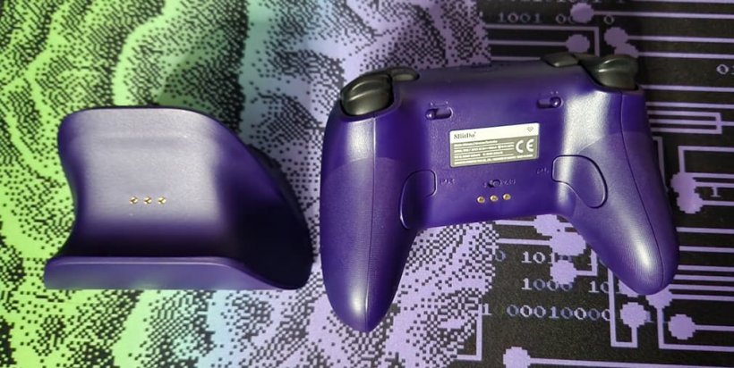 back view of Ultimate 2 wireless controller next to mstching charging dock
