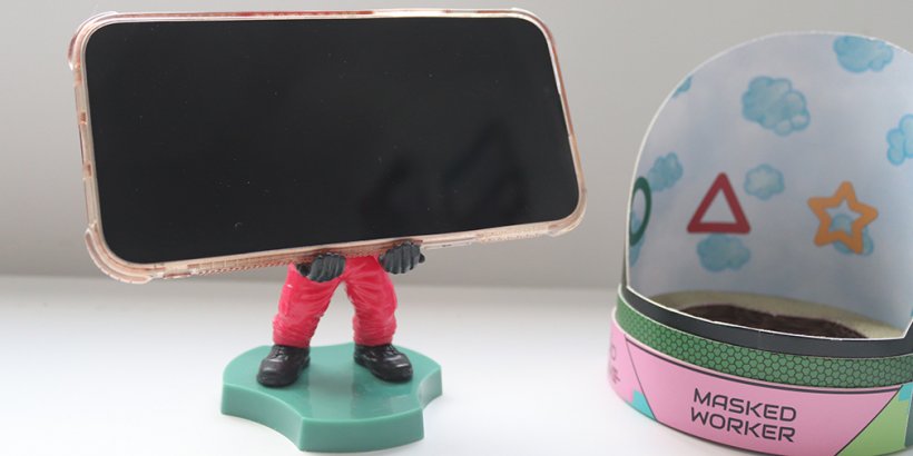 Cable Guy's Mini Masked Worker holding a phone